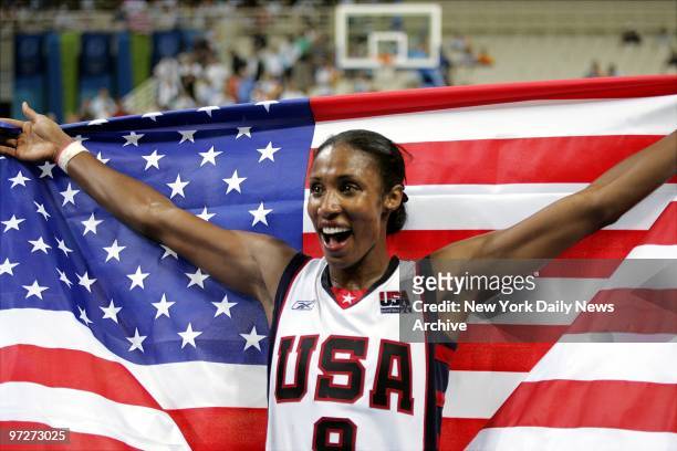 Lisa Leslie of the U.S. Joyfully holds up an American flag after the women's basketball team defeated Australia, 74-63, in the gold medal match at...