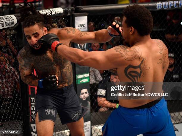 Greg Hardy punches Austen Lane in their heavyweight bout during Dana White's Tuesday Night Contender Series at the TUF Gym on June 12, 2018 in Las...