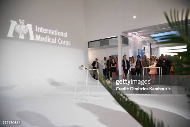 Guests attend the International Medical Corps summer cocktail event hosted by Sienna Miller and Milk Studios at Milk Studios on June 12, 2018 in New...