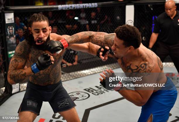 Greg Hardy punches Austen Lane in their heavyweight bout during Dana White's Tuesday Night Contender Series at the TUF Gym on June 12, 2018 in Las...