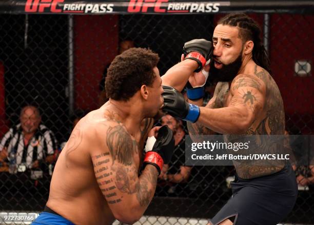 Greg Hardy punches Austen Lane in their heavyweight bout during Dana White's Tuesday Night Contender Series at the TUF Gym on June 12, 2018 in Las...