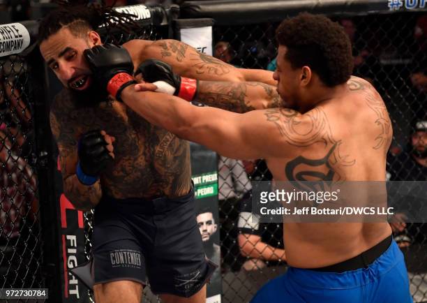 Greg Hardy punches Austen Lane in their heavyweight bout during Dana White's Tuesday Night Contender Series at the TUF Gym on June 12, 2018 in Las...