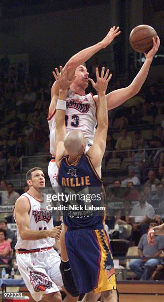 Ben Knight of the Cairns Taipans lays the ball in over John Rillie of the West Sydney Razorbacks during the NBL match between the West Sydney...