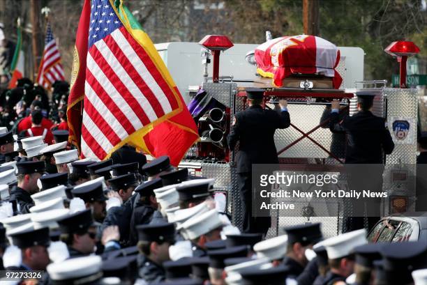 Firefighters salute as fire truck bearing the coffin of FDNY Lt. Curtis Meyran leaves Our Lady of Lourdes Church in Malverne, L.I. Meyran and his...