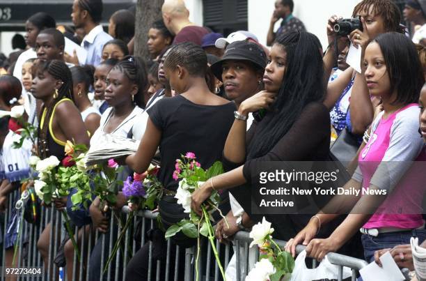 Mourning fans line the streets outside St. Ignatius Loyola Roman Catholic Church at 84th St. And Park Ave. As pallbearers carry the casket of R&B...