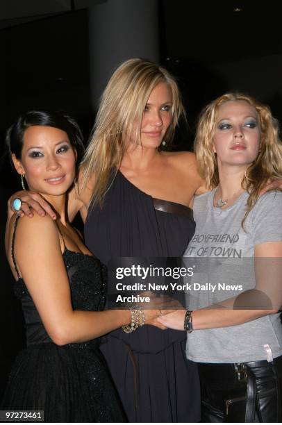 Lucy Liu, Cameron Diaz and Drew Barrymore huddle at a showing of "Charlie's Angels: Full Throttle" at the Sony Lincoln Square theater. They star in...