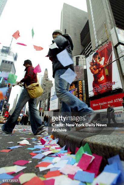 Confetti flutters by pedestrians at 46th St. And Broadway as the Times Square Alliance does their annual confetti flight test in preparation for the...