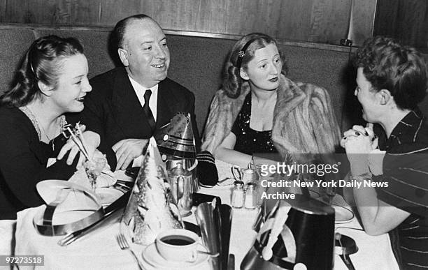 Movie director Alfred Hitchcock is joined by his daughter, Patricia ; Mrs.Leonard Lyons, wife of the newspaper columnist, and Hitchcock's wife, Alma...