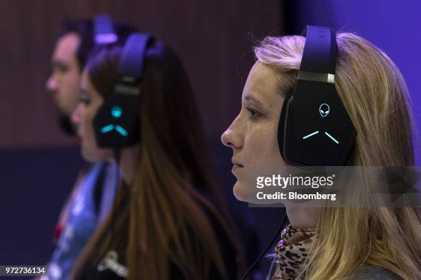 Attendees wear Alienware Corp. Headsets while playing the Frontier Developments Plc Jurassic World Evolution video game during the E3 Electronic...