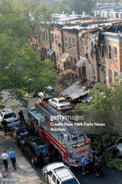 Firefighters survey damage to the roof of a building on 58th St. Between Sixth and Seventh Aves. In the Sunset Park section of Brooklyn, after a...