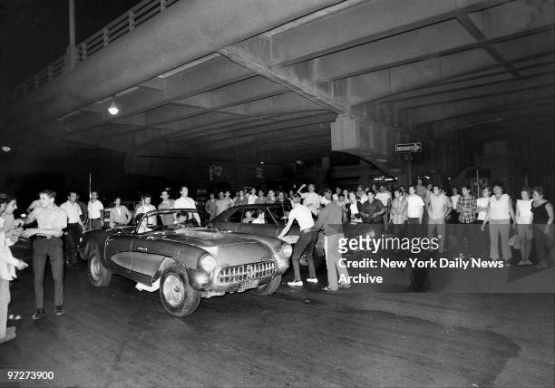 The crowd thrills with anticipation as two young drivers line up their cars as Corvette and hardtop, rev the souped-up engines and wait for start....