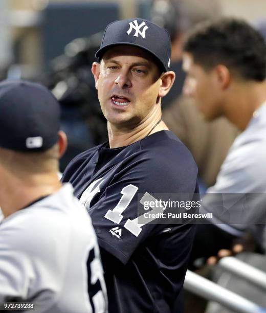 Manager Aaron Boone of the New York Yankees looks over in the dugout during an interleague MLB baseball game against the New York Mets on June 8,...