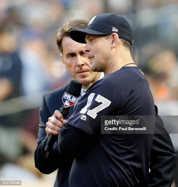 Manager Aaron Boone of the New York Yankees is interviewed on the field by MLB announcer Tom Verducci between innings during an interleague MLB...