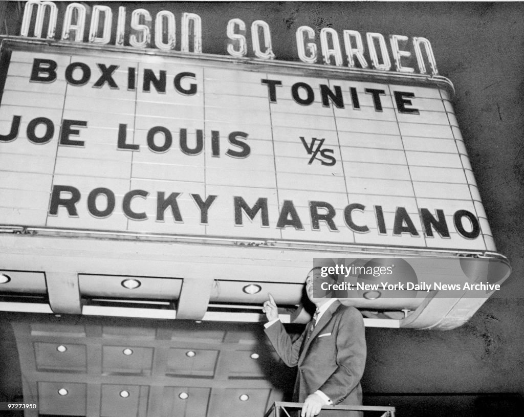 Boxer Joe Louis in front of marquee at Madison Square Garden