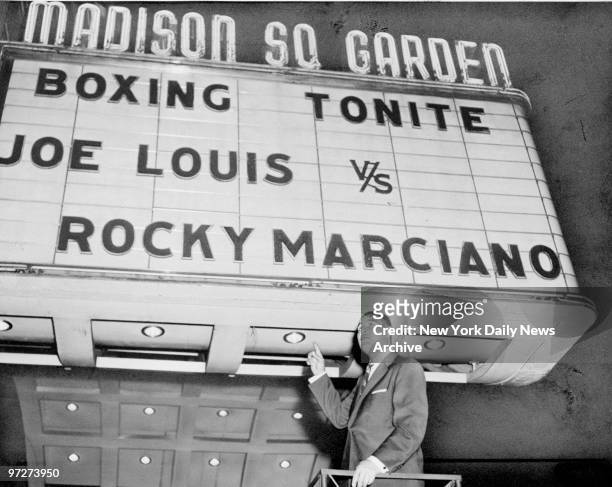 Boxer Joe Louis in front of marquee at Madison Square Garden. The marquee was set up for the filming of "The Joe Louis Story."