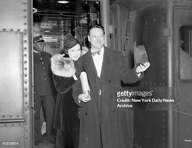 Mr. And Mrs. Lou Gehrig wave good-bye at Penn Station. Lou lost no time in leaving for the Yankees St. Petersburg training camp after he agreed to...