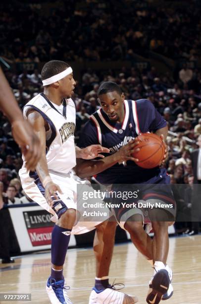 Connecticut Huskies' Ben Gordon drives for the basket around Pittsburgh Panthers' defender during Big East championship game at Madison Square...