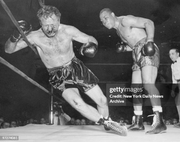 Boxer Lee Savold is knocked out by Joe Louis. Savold dropped in the sixth round of a scheduled 15-round bout at Madison Square Garden.