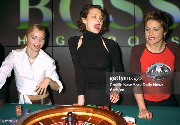 Izabella Miko, Shalom Harlow and Mariska Hargitay watch the spinning wheel at Vegas Night in the Hugo Boss store on Fifth Ave. Proceeds of the gaming...