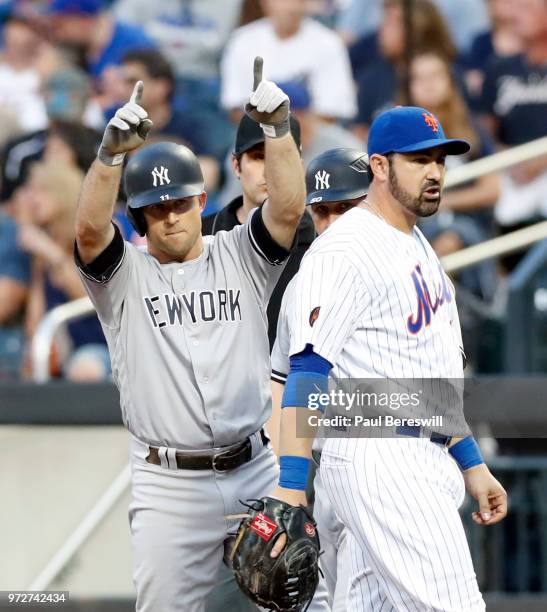 Brett Gardner of the New York Yankees reacts after hitting a single as Adrian Gonzalez of the New York Mets looks over during an interleague MLB...