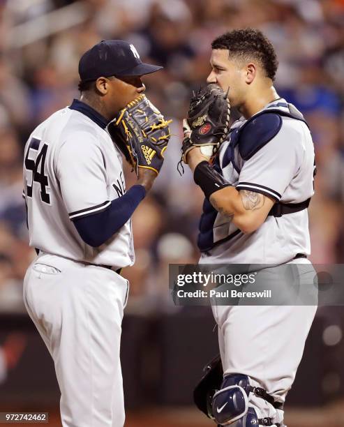 Pitcher Aroldis Chapman and catcher Gary Sanchez of the New York Yankees stop to talk on the mound in an interleague MLB baseball game against the...