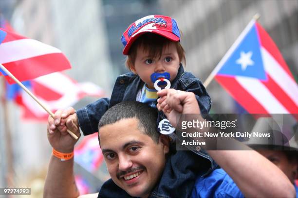 Jacob Alexander Torres, 11 months, enjoys the view from his dad Joel Torres' shoulders during the 50th annual Puerto Rican Day Parade along Fifth Ave.