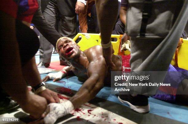 Boxer Richard Grant lies bleeding on the mat after his defeated opponent, James Butler, sucker-punched him following their match at "Fighting For...