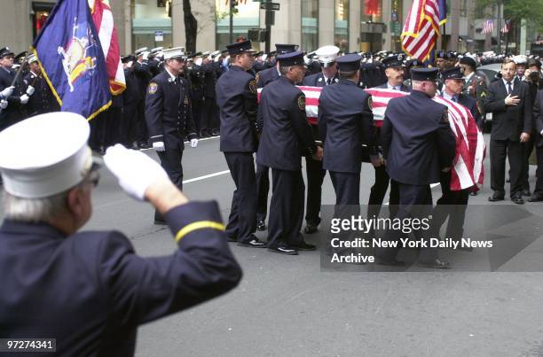 Firefighters, some of whom came straight from rescue work at the site of the former World Trade Center, salute their fallen comrade, Lt. Dennis...