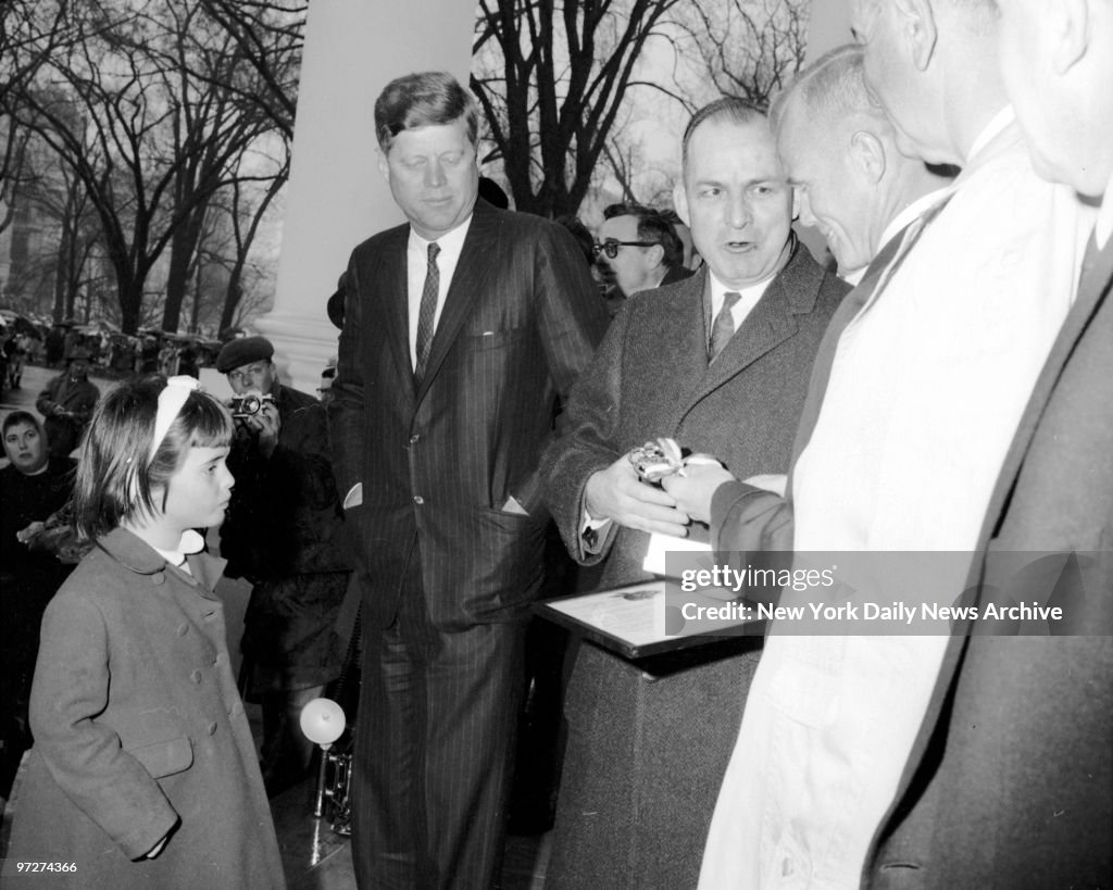 Little Maria Shriver, the President's niece, watches in admi