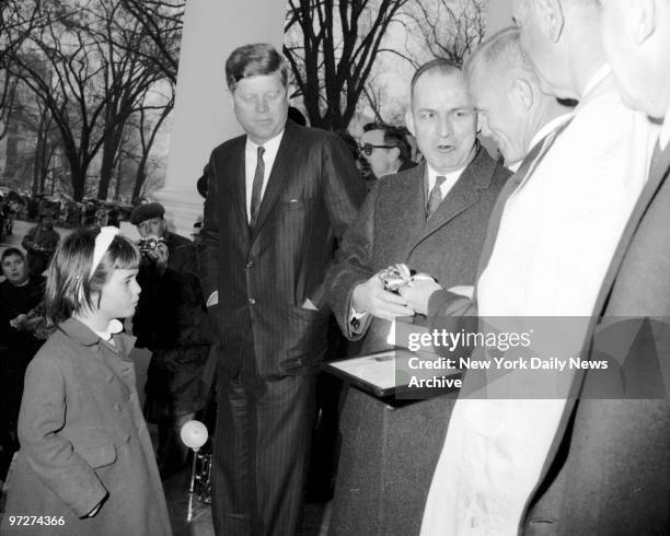 Little Maria Shriver, the President's niece, watches in admiration as Fred Clark, District of Columbia commissioner, presents astronaut Lt. Col. John...