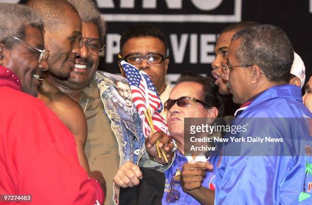 Boxers Bernard Hopkins and Felix Trinidad face off against each other after their weigh-in at Madison Square Garden as promoter Don King grins. The...