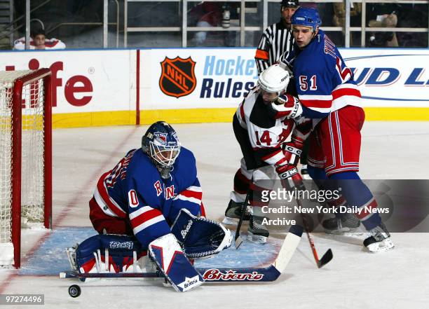 New York Rangers' goalie Jussi Markkanen deflects shot of New Jersey Devils' Brian Gionta as Rangers' Fedor Tyutin looks on during second period of...