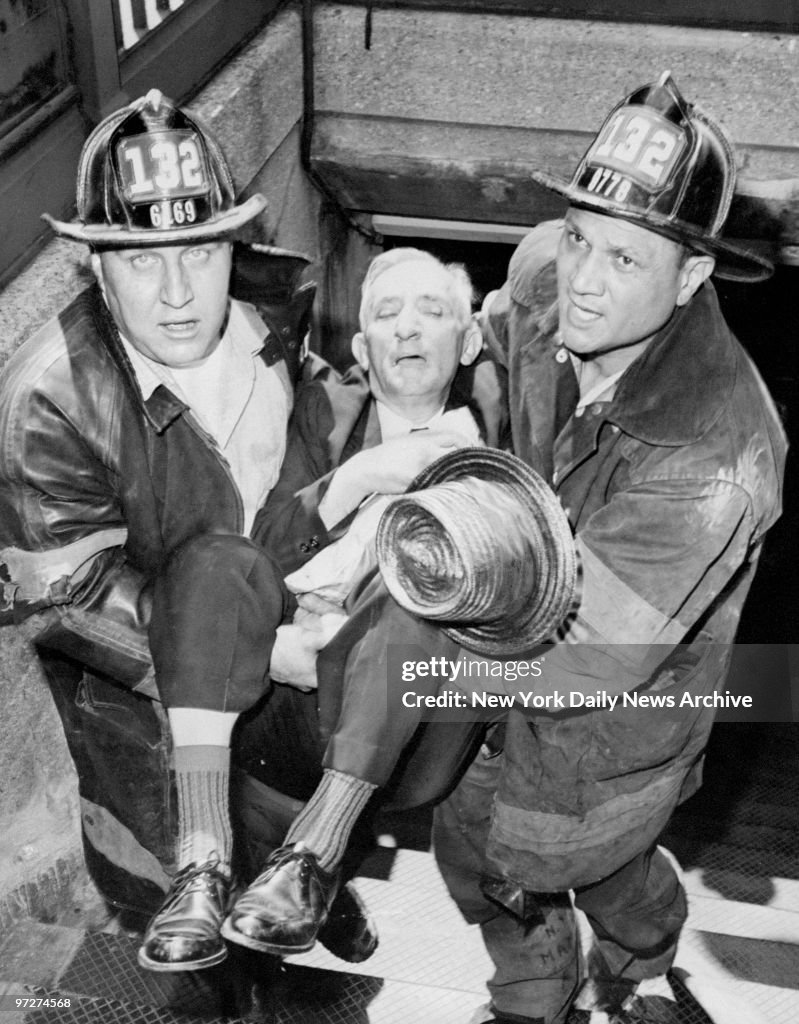 Firemen Firemen carry victim overcome by smoke in subway fire to safety. News ...