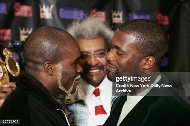 Boxing promoter Don King looks on as Jean-Marc Mormeck of France faces down O'Neil Bell of the U.S. During a news conference at Madison Square Garden...