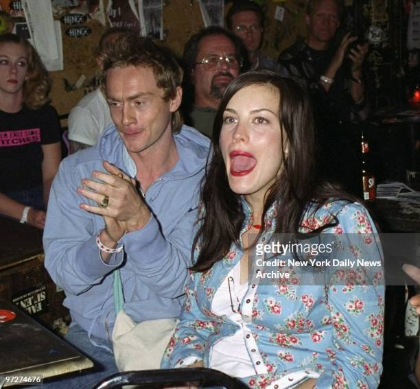 Liv Tyler and fiance Royston Langdon of the band Spacehog take in a performance by Tyler's mom, Bebe Buell, at a benefit and auction for Foxe-Tyler...