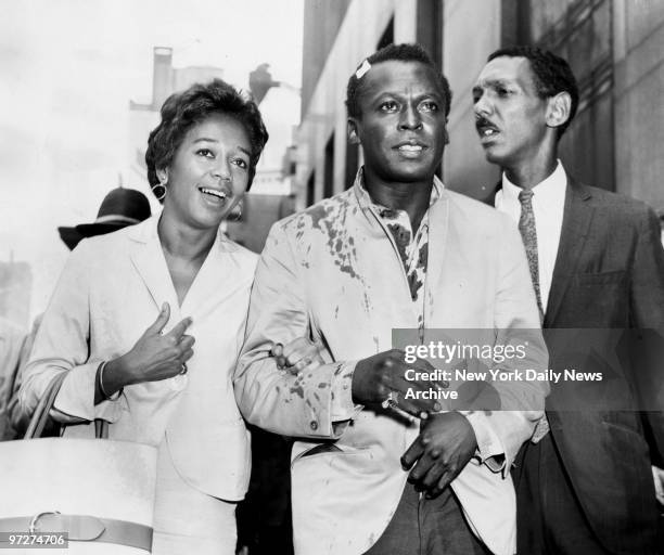 Mrs. Frances Davis with her husband, Miles Davis, jazz musician, who was released on $500 bail. At right is his attorney, Harold E. Lovette.