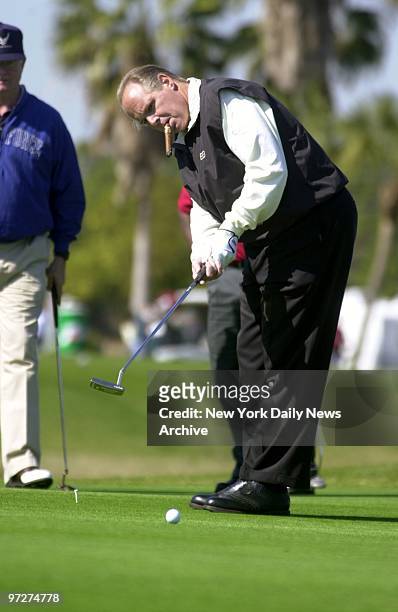 Conservative radio talk-show host Rush Limbaugh puffs and putts at an NFL Shootout at MacDill Air Force Base Golf Course in Tampa.