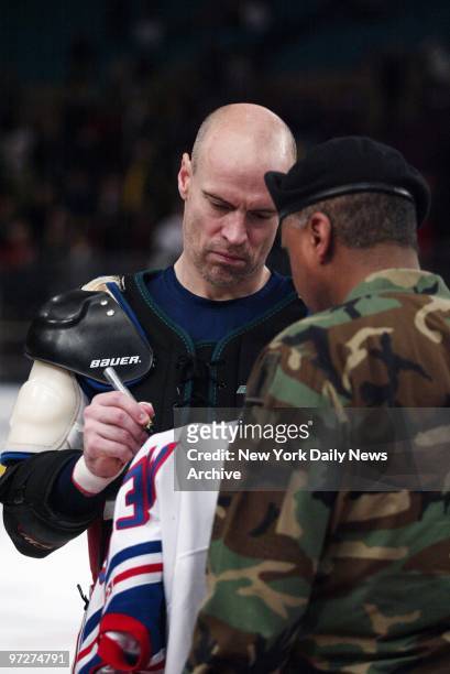 New York Rangers' Mark Messier autographs his jersey for Sgt. Maj. Chet Markus of the 77th Army Reserve from Fort Totten in Bayside, Queens, on Fan...