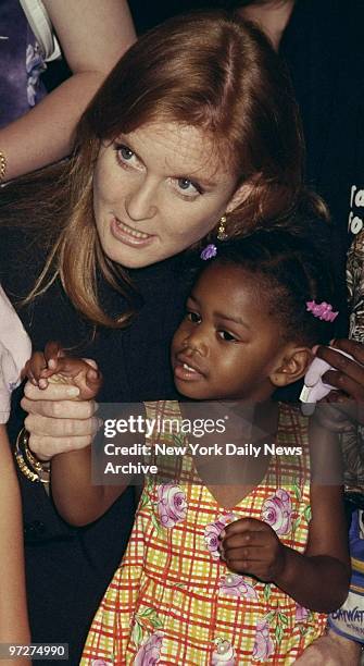 The Duchess of York Sarah Ferguson, meets 3-year-old Nyla Jones at the New York Historical Society exhibition "Kid City."
