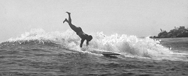 The Duke Still At It" - Daily sight at Corona De Mar beach, CA, if this: It is Duke Kahanamoku, noted swimmer, doing one of his stunts with a...