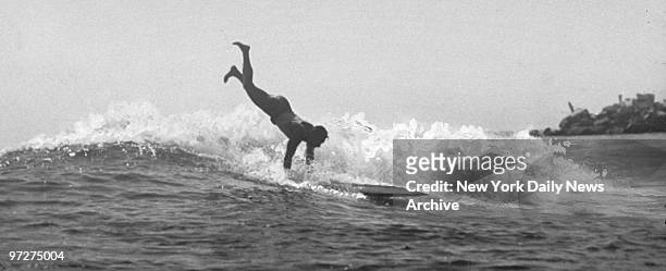 The Duke Still At It" - Daily sight at Corona De Mar beach, CA, if this: It is Duke Kahanamoku, noted swimmer, doing one of his stunts with a...
