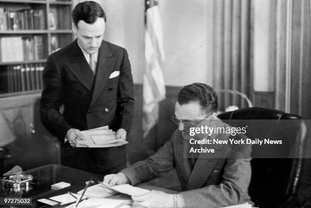 Edgar Hoover , chief of the Division of Investigation of the Department of Justice, and his assistant, Clyde Tolson, working diligently at the...