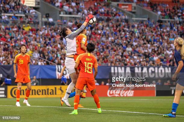 China PR goalkeeper Peng Shimeng reaches over China PR defender Wu Haiyan to make a save during the second half of the International Friendly between...