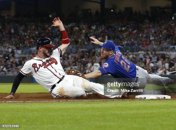 Third baseman Todd Frazier of the New York Mets tags out catcher Tyler Flowers of the Atlanta Braves at third base in the sixth inning during the...