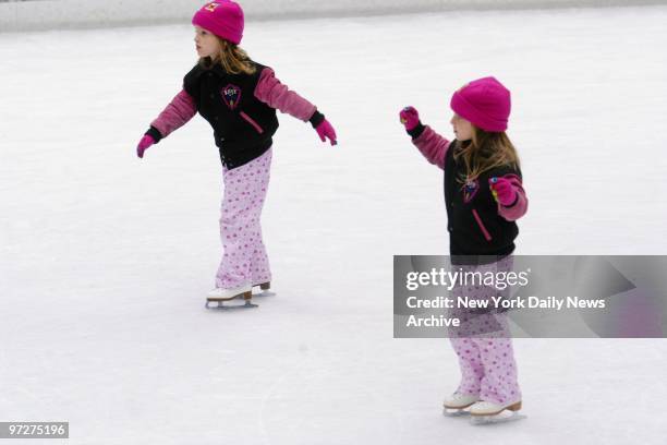 Scarlet and Amber Aylsworth take a turn on the ice during a skating lesson at the Rockefeller Center rink. The 4-year-old identical twins are the...