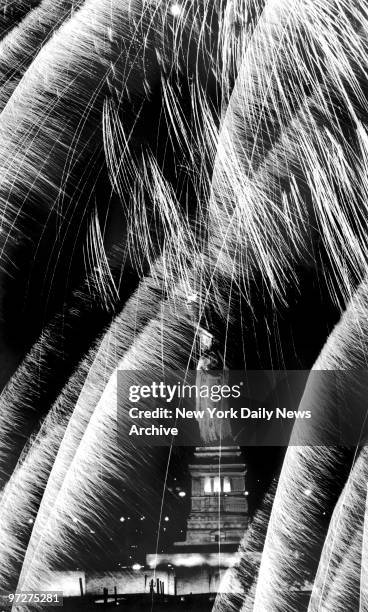 Fireworks explode around Statue of Liberty during the Liberty Weekend party to mark the statue's centennial year as a beacon of hope and welcome to...
