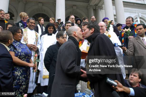 Bradley Curry and partner Mel Bryant kiss after they exchanged vows on the steps of City Hall. Montel and Michelle Cherry-Slack, waiting their turn...