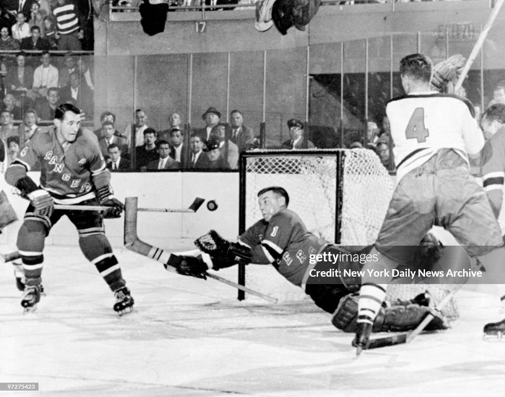 New York Rangers' Gump Worsley catching a puck in a game aga