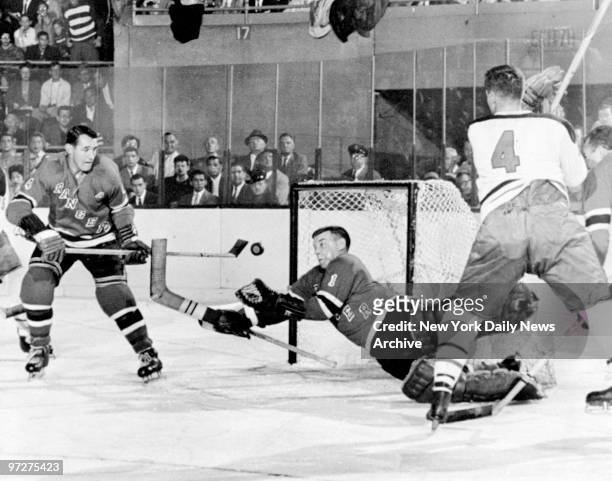 New York Rangers' Gump Worsley catching a puck in a game against Montreal.