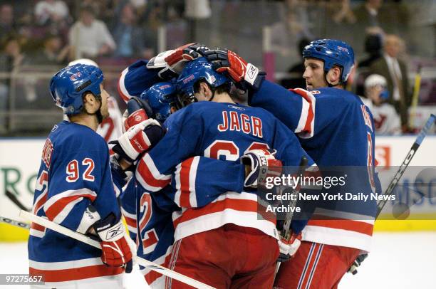 New York Rangers' Jaromir Jagr is congratulated by Michael Nylander , Marek Malik and other teammates after scoring the Rangers' fourth goal of the...